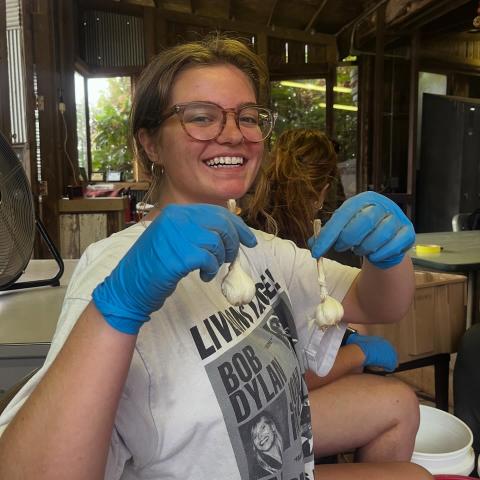 Apprentice Mae holds garlic